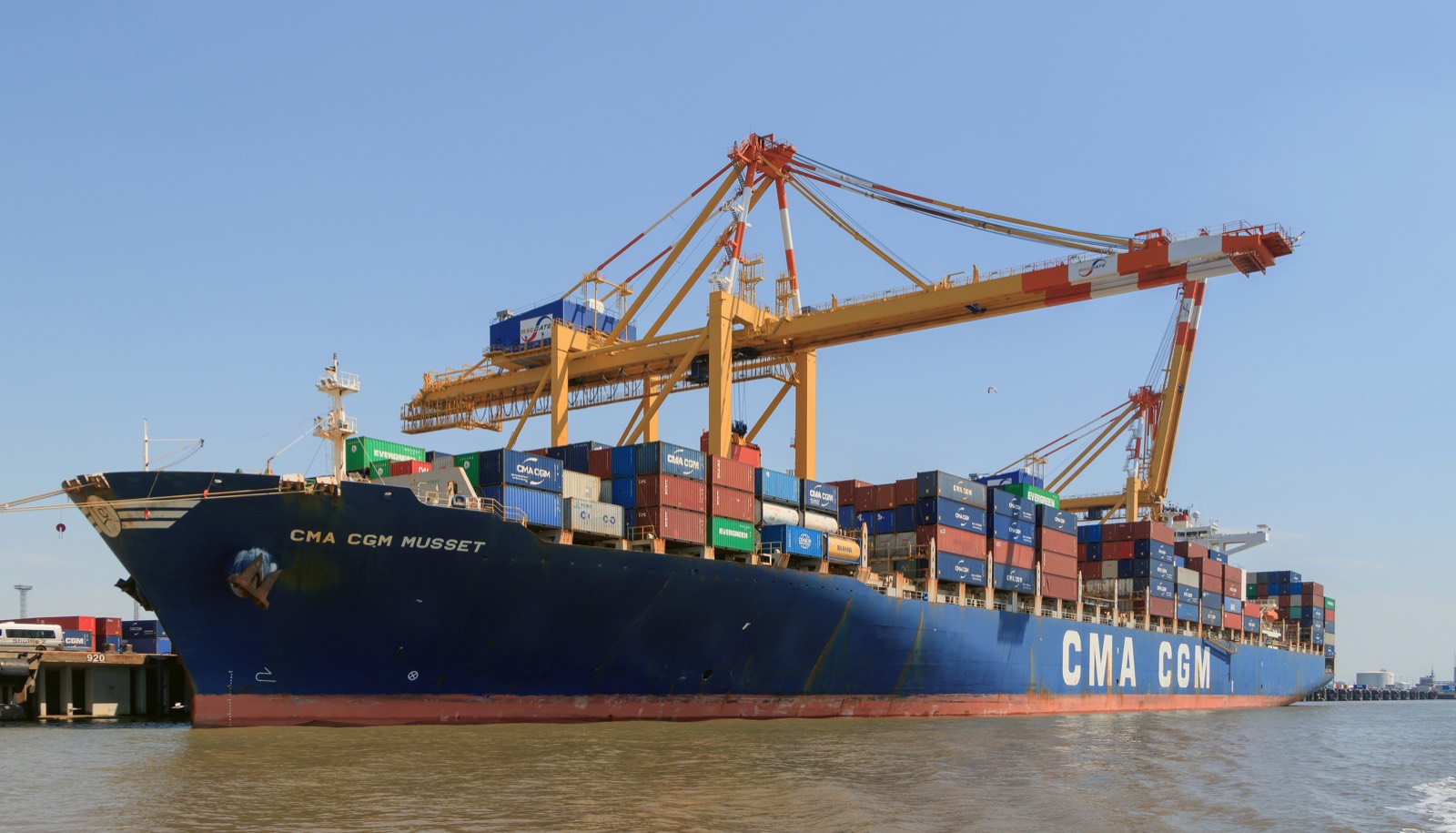 Container vessel working cargo at a terminal